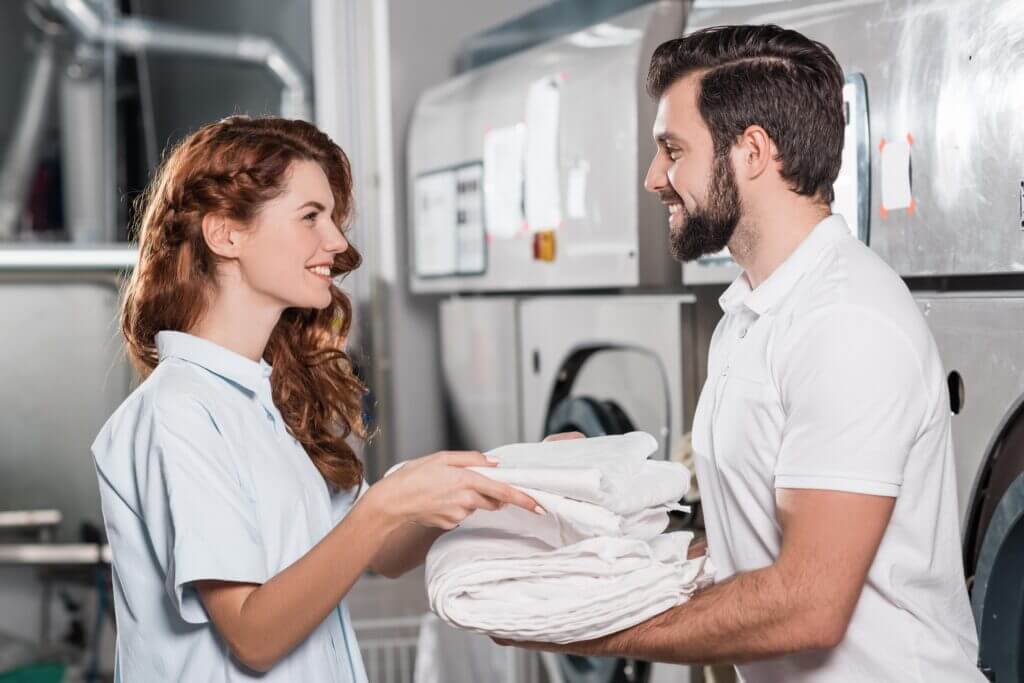 2 people folding clean linens