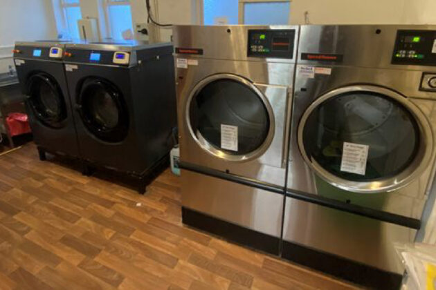 Two Lavamac commercial washing machines and two Huebsch commercial tumble dryers