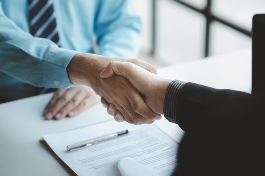 Two men shaking hands.
